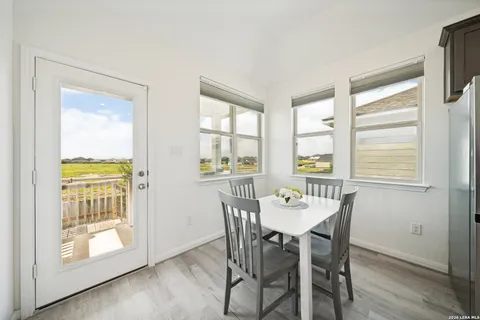 a view of a dining room with furniture and a window