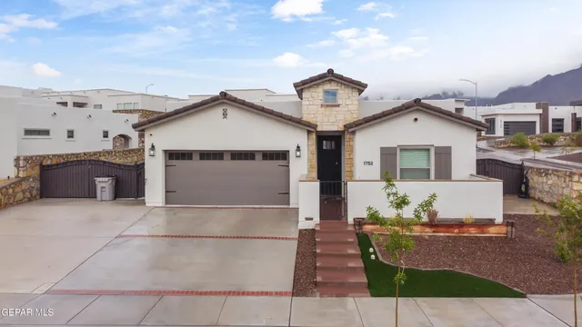 a front view of a house with a garage