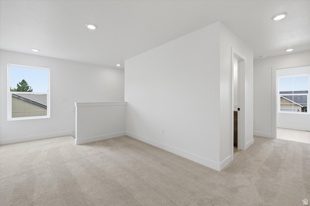 844 North 400 West Logan, UT 84321 - Photo 17 of 43 Expansive carpeted area featuring recessed lighting, multiple windows, and crisp white walls