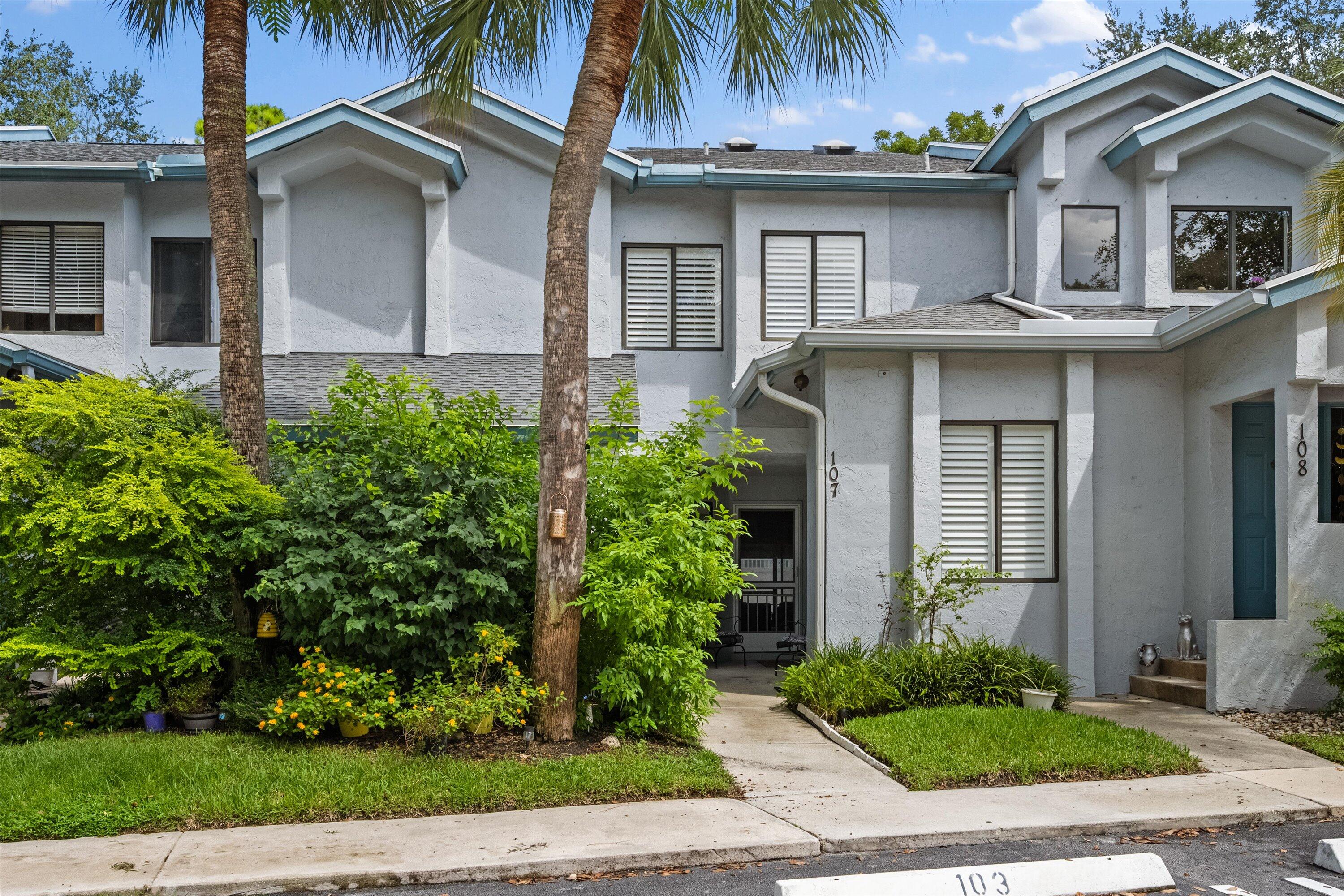 103 Harbour Pointe Way Greenacres, FL 33413 - Photo 1 of 32 a front view of a house with a garden