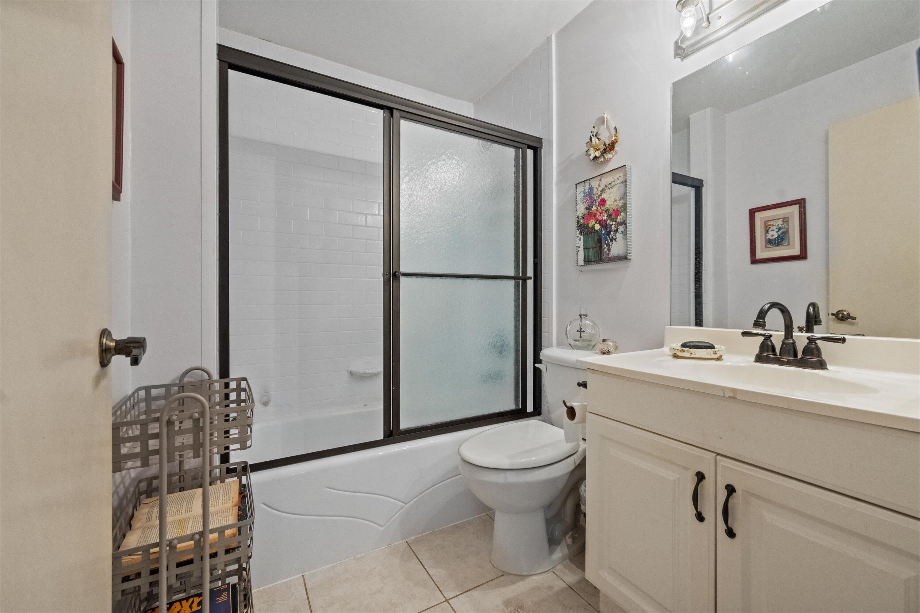 103 Harbour Pointe Way Greenacres, FL 33413 - Photo 18 of 32 a white toilet sitting next to a bathroom sink