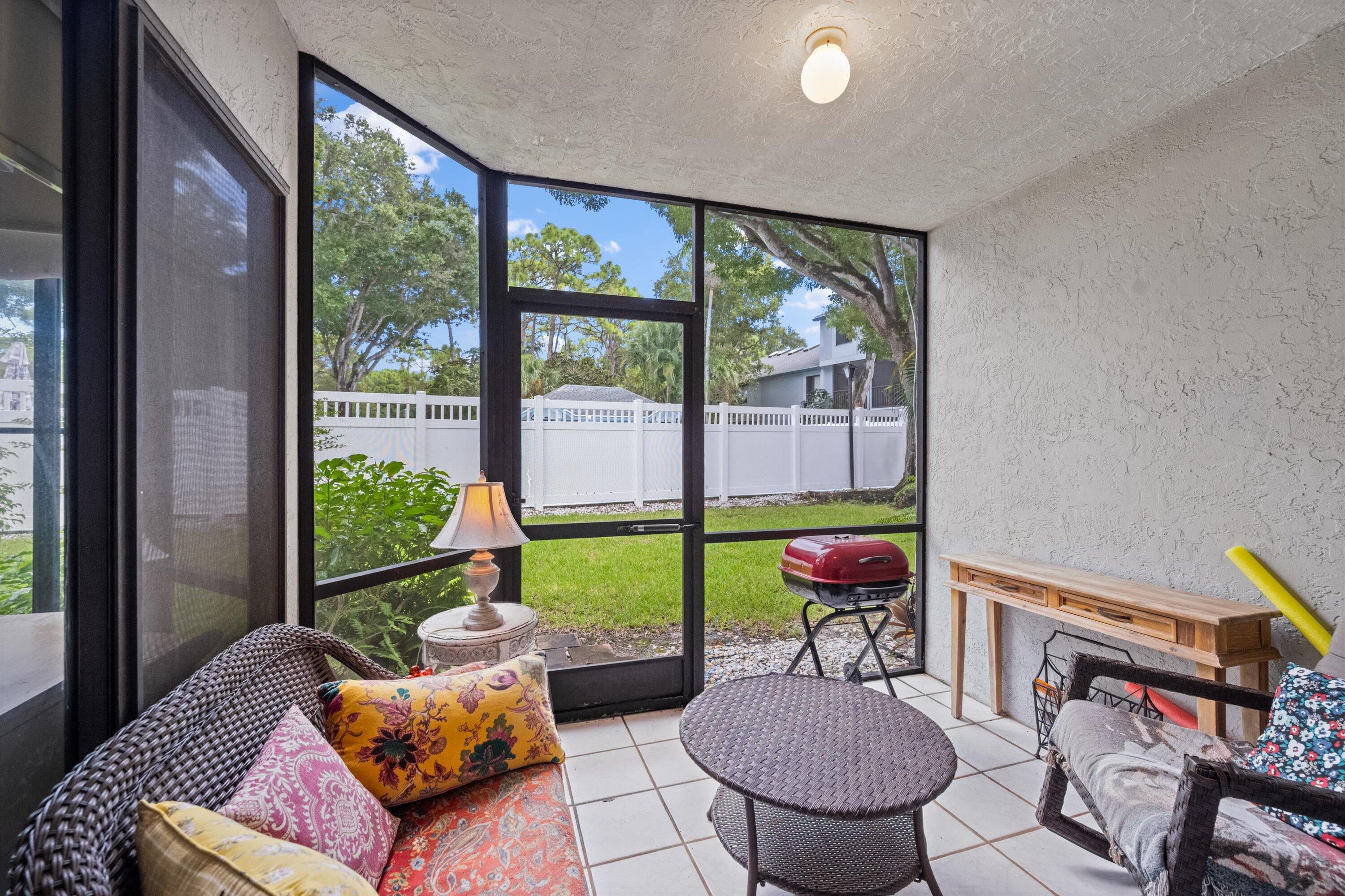 103 Harbour Pointe Way Greenacres, FL 33413 - Photo 20 of 32 a living room with furniture and a floor to ceiling window