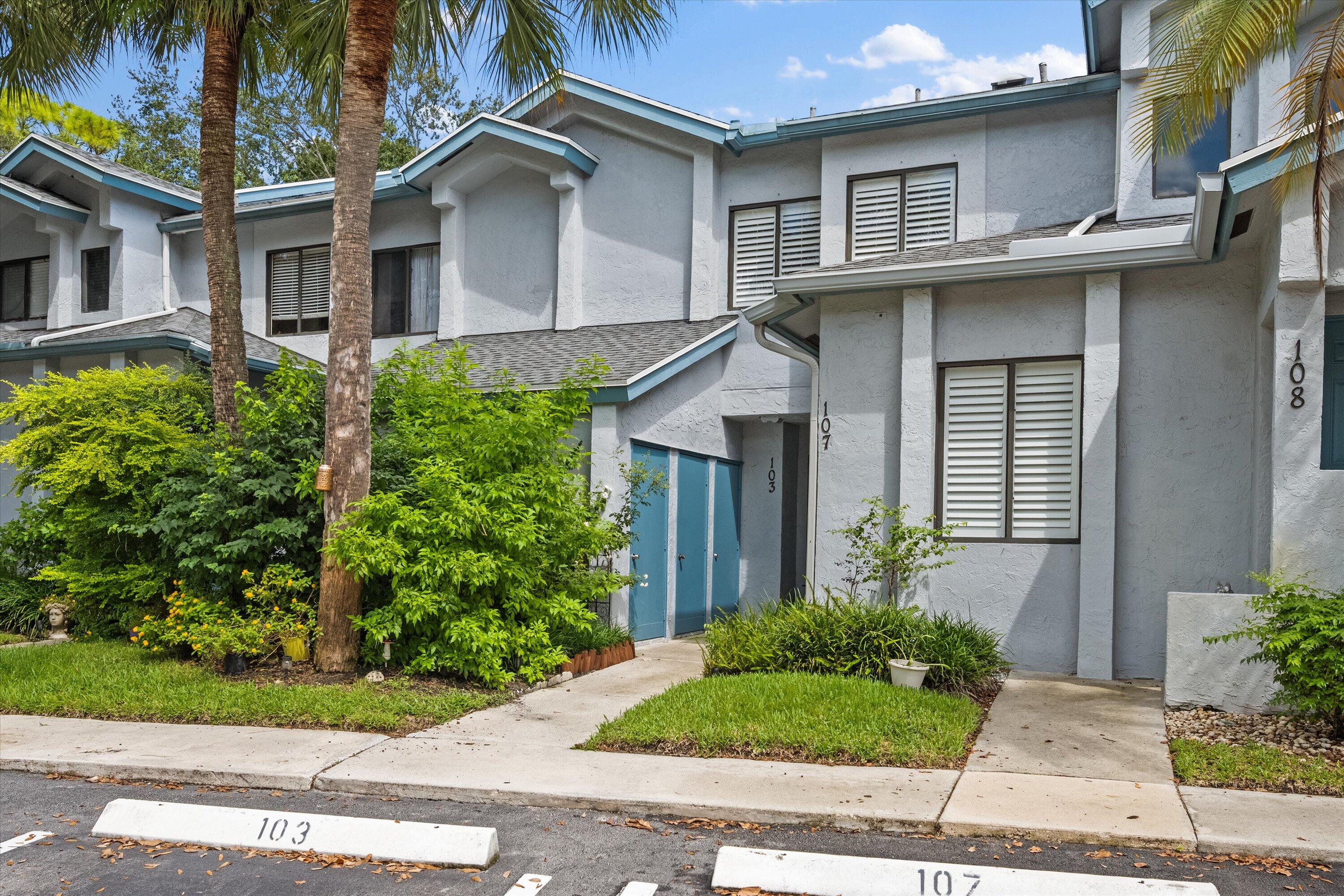 103 Harbour Pointe Way Greenacres, FL 33413 - Photo 2 of 32 a view of a white house next to a yard
