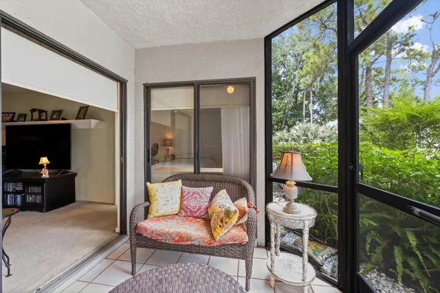 a living room with furniture and a floor to ceiling window