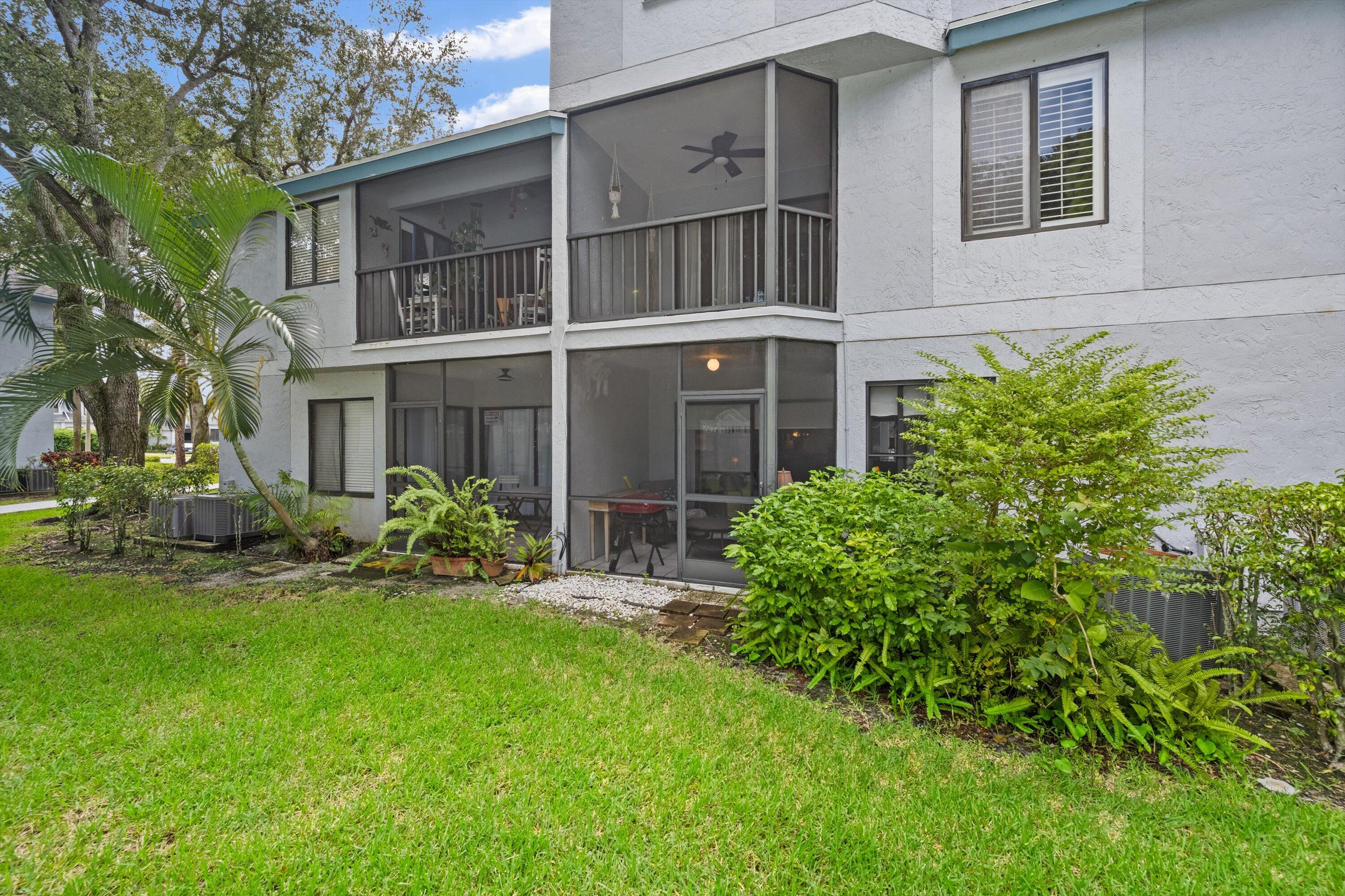 103 Harbour Pointe Way Greenacres, FL 33413 - Photo 23 of 32 a house with a tree front of it
