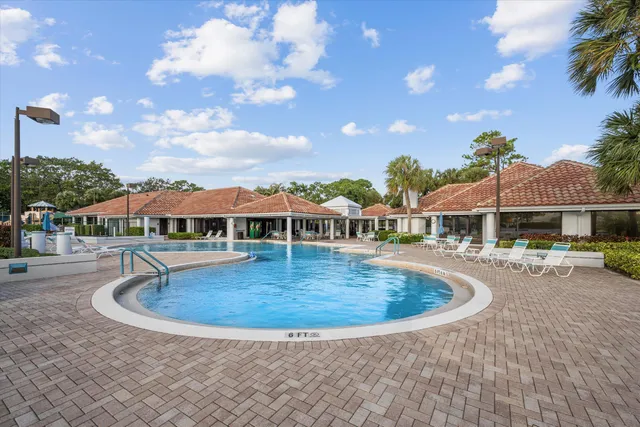 a view of a house with swimming pool and sitting area
