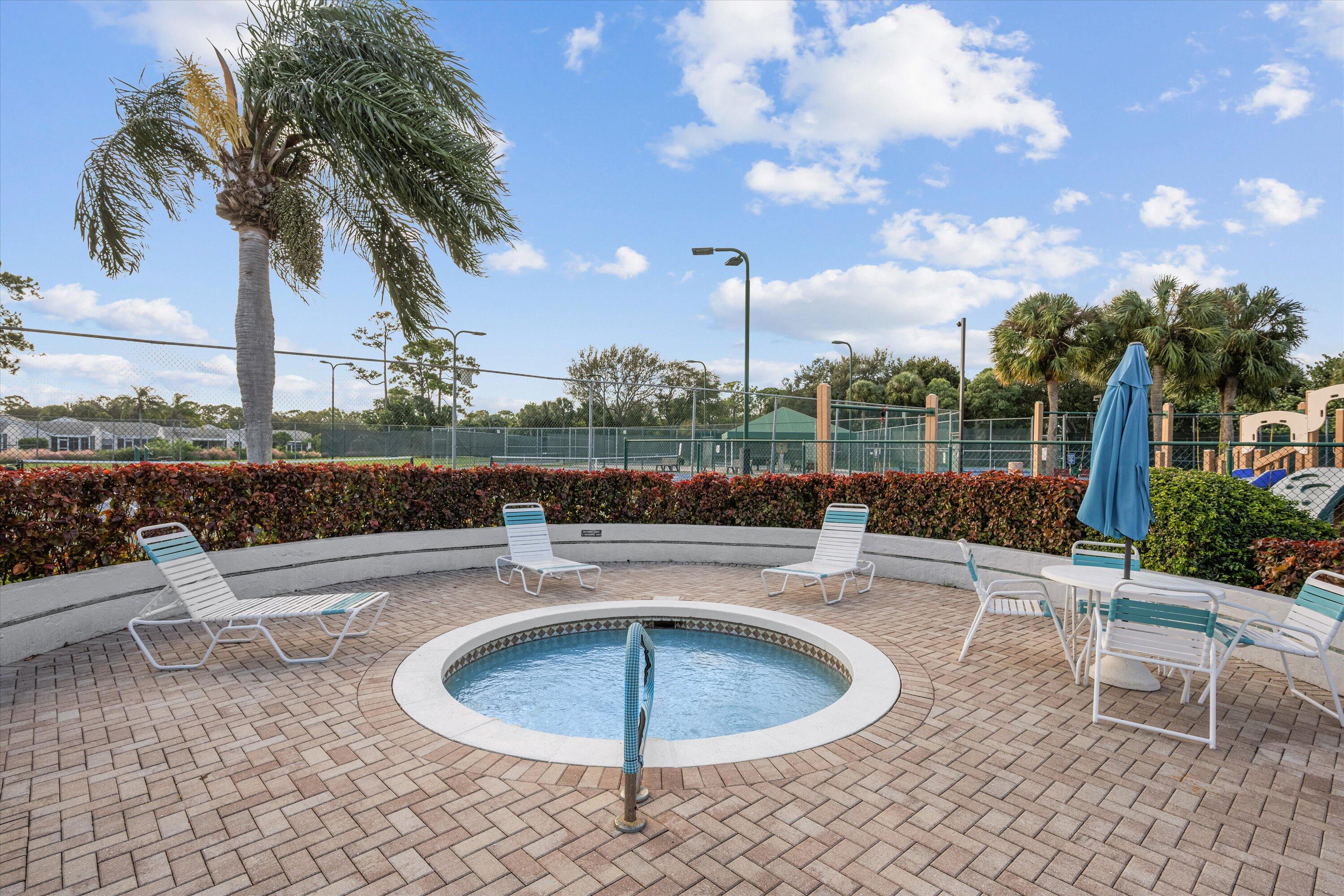 103 Harbour Pointe Way Greenacres, FL 33413 - Photo 30 of 32 a view of a swimming pool with a patio and a garden