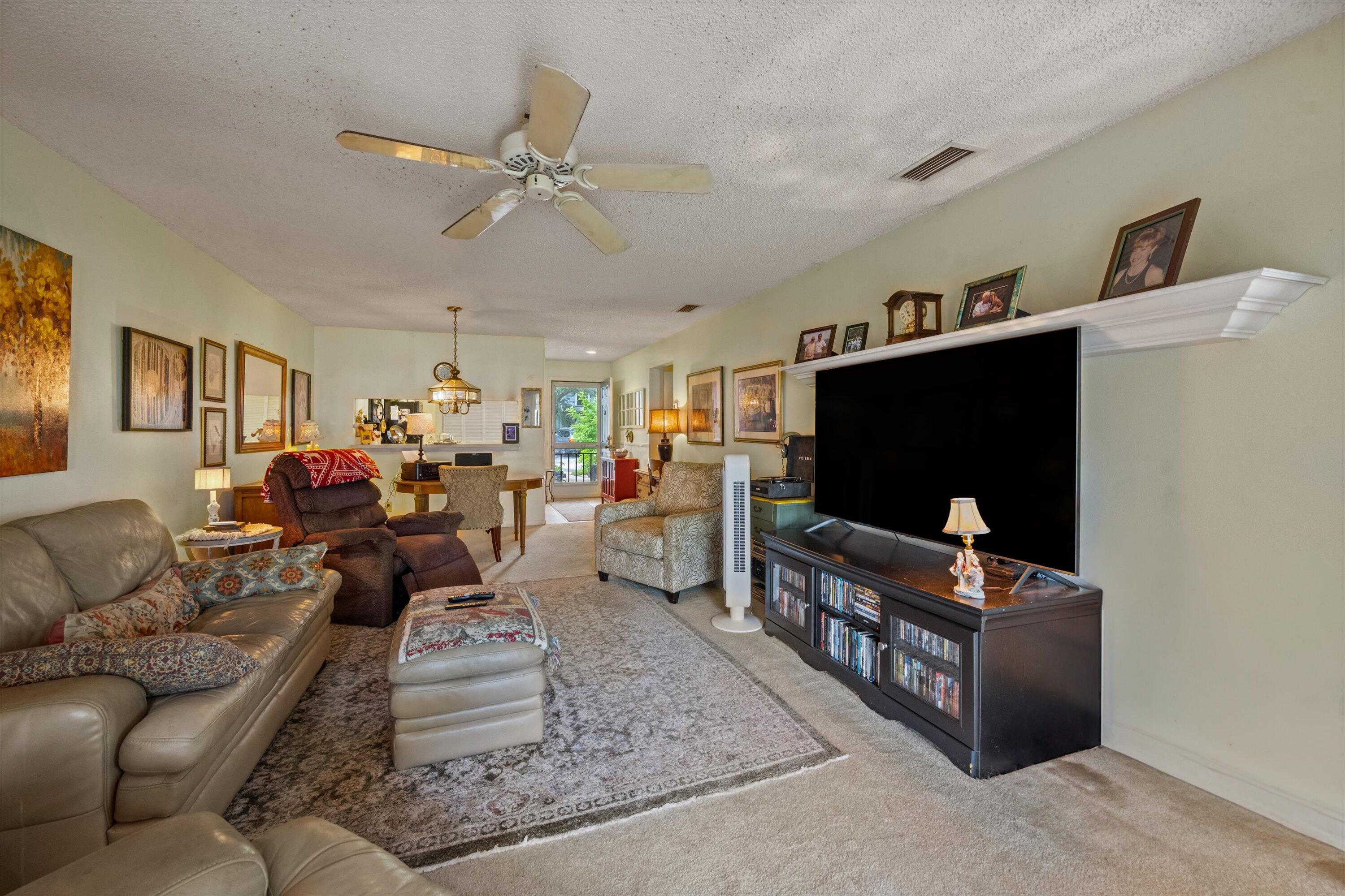 103 Harbour Pointe Way Greenacres, FL 33413 - Photo 6 of 32 a living room with furniture and a flat screen tv