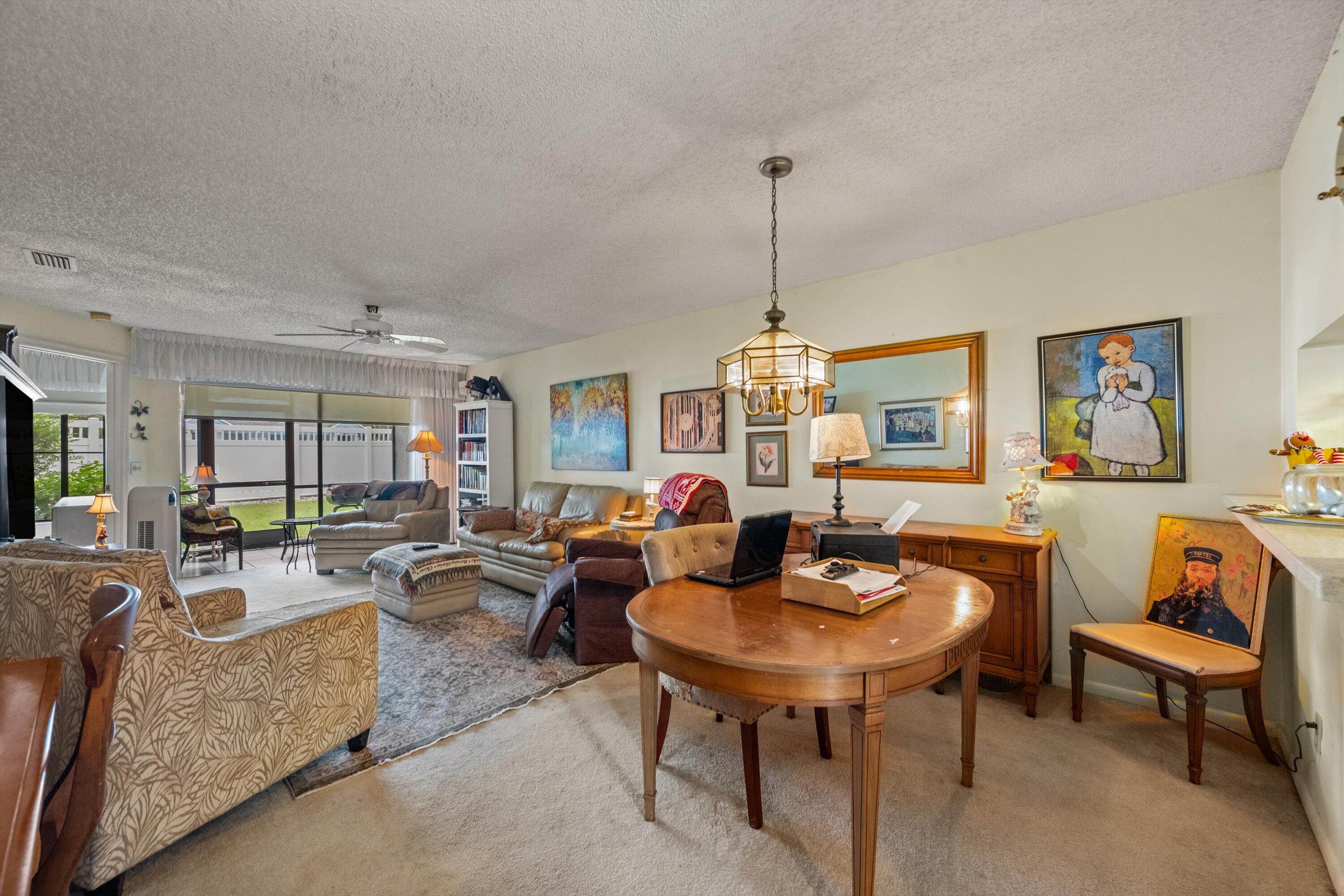 103 Harbour Pointe Way Greenacres, FL 33413 - Photo 7 of 32 a living room with furniture and a table