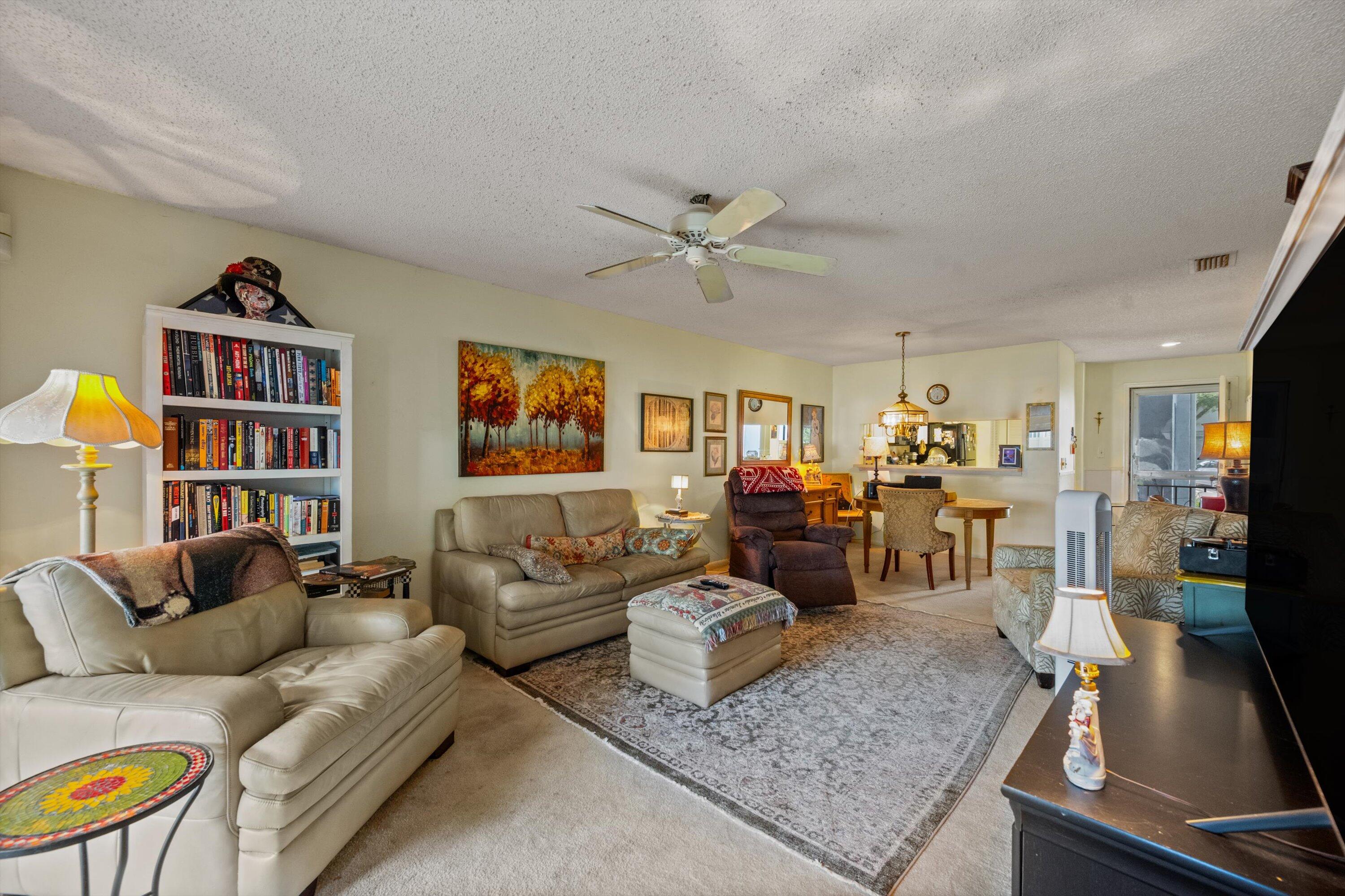 103 Harbour Pointe Way Greenacres, FL 33413 - Photo 8 of 32 a living room with furniture and a flat screen tv