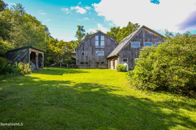 a view of a house with a yard and garden