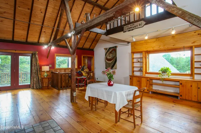 a living room with lots of furniture and a dining table with kitchen view