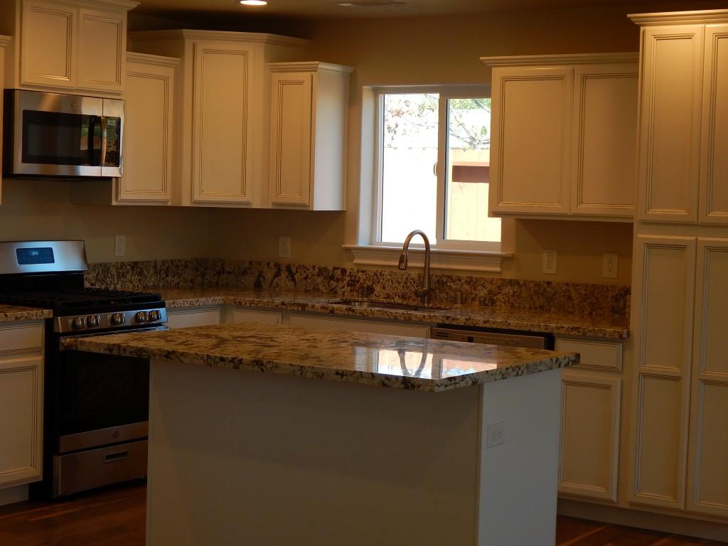 11341 Puffin Way Redding, CA 96003 - Photo 12 of 25 a kitchen with stainless steel appliances granite countertop a stove a sink and a microwave