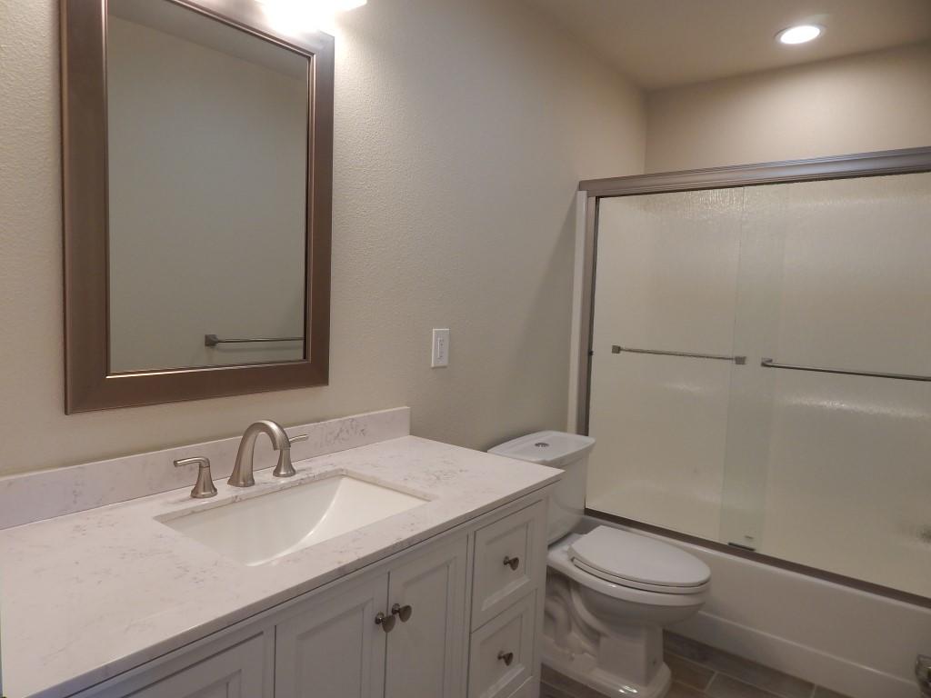 11341 Puffin Way Redding, CA 96003 - Photo 14 of 25 a bathroom with a granite countertop sink toilet and shower