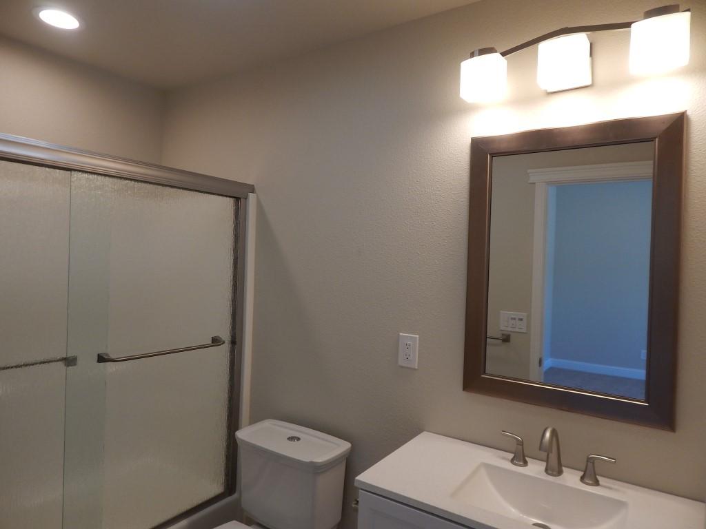 11341 Puffin Way Redding, CA 96003 - Photo 17 of 25 a bathroom with a toilet a sink and shower