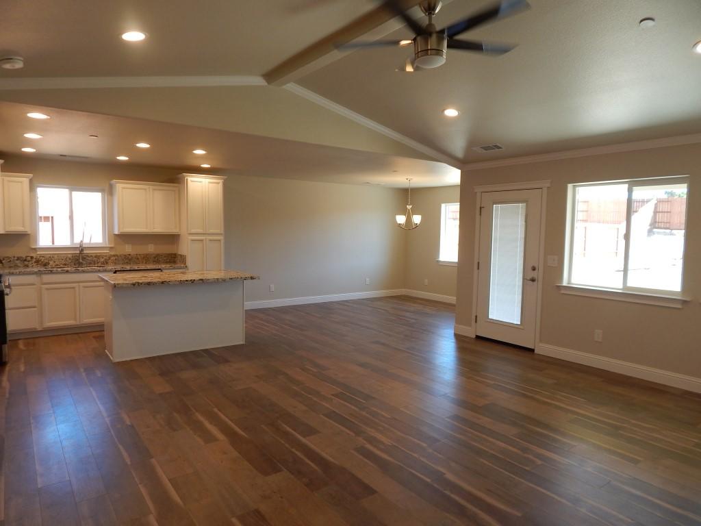 11341 Puffin Way Redding, CA 96003 - Photo 25 of 25 an empty room with wooden floor and windows