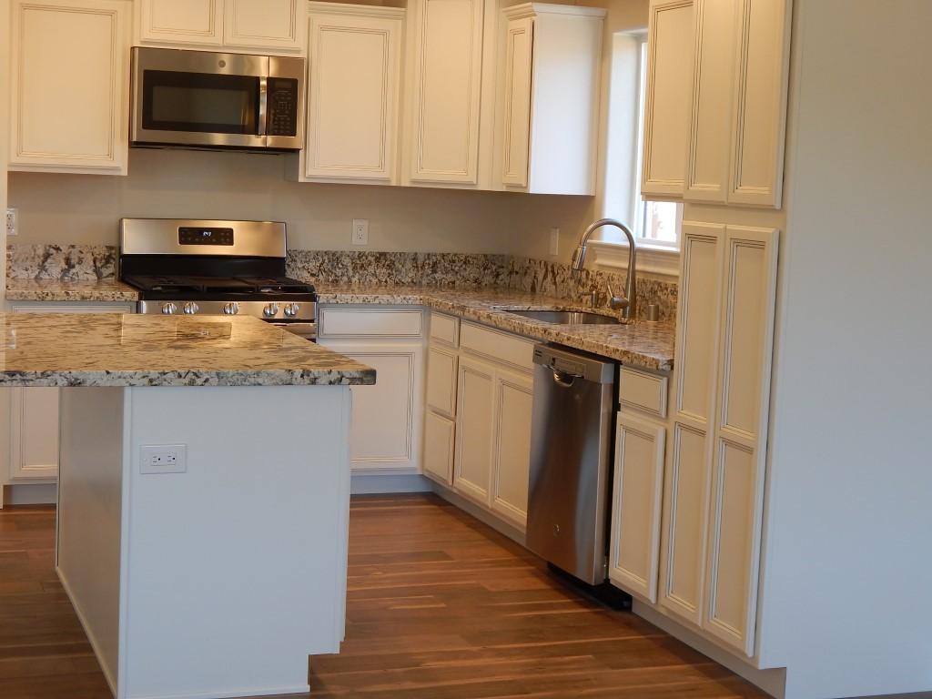 11341 Puffin Way Redding, CA 96003 - Photo 9 of 25 a kitchen with stainless steel appliances granite countertop a stove a sink and a microwave