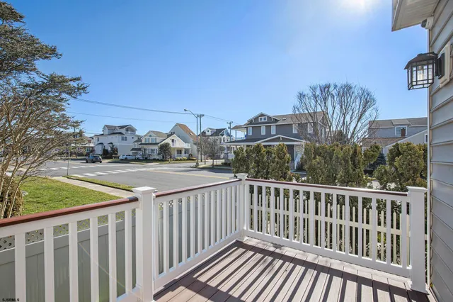 a view of balcony with wooden floor and fence