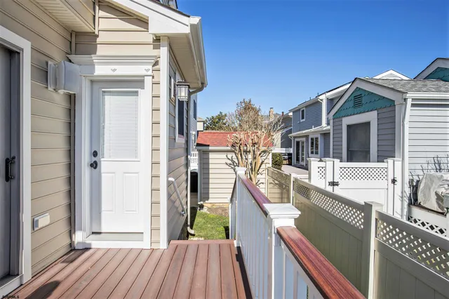 a view of a balcony with wooden floor and fence