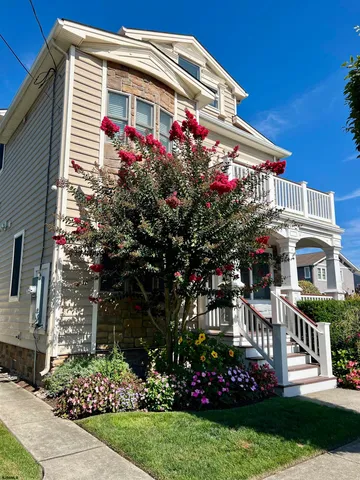a front view of multi story residential apartment building with yard