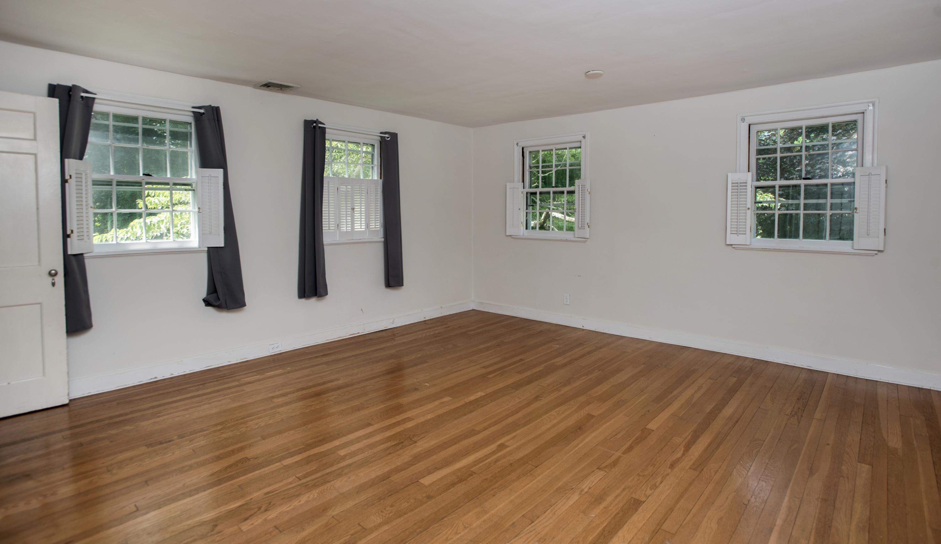 65 Oenoke Ridge New Canaan, CT 06840 - Photo 15 of 22 a view of an empty room with wooden floor and windows