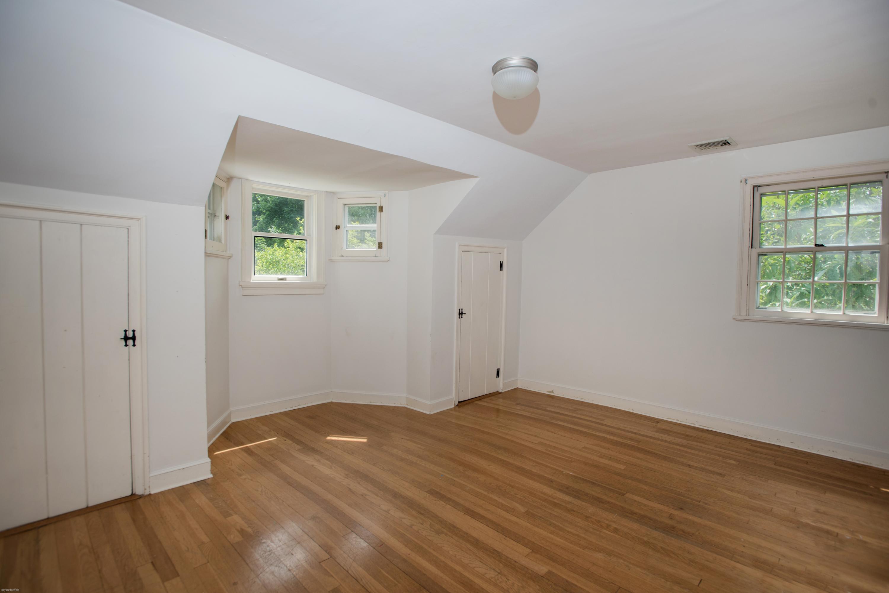 65 Oenoke Ridge New Canaan, CT 06840 - Photo 16 of 22 an empty room with wooden floor and windows