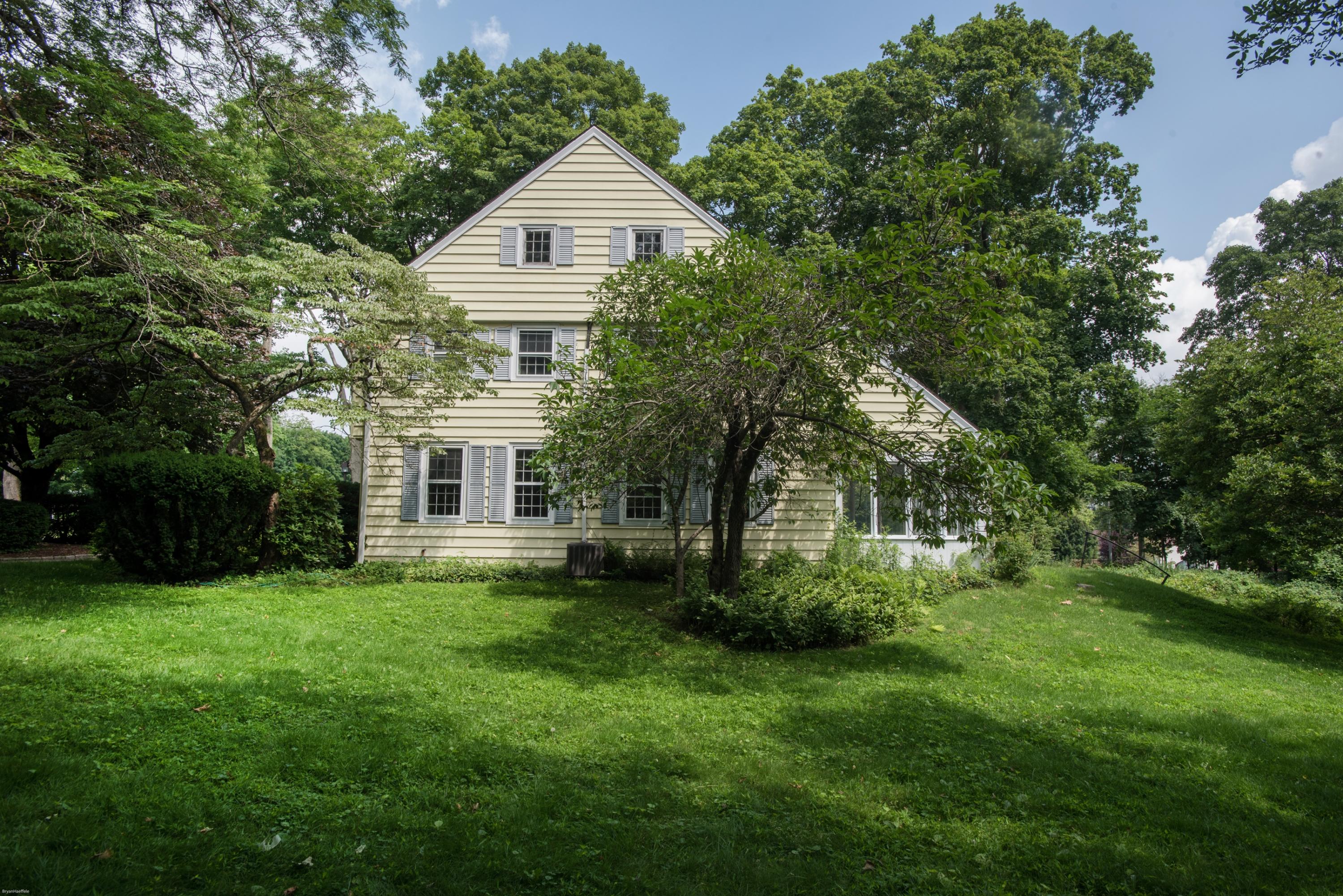 65 Oenoke Ridge New Canaan, CT 06840 - Photo 19 of 22 a front view of house with yard and green space