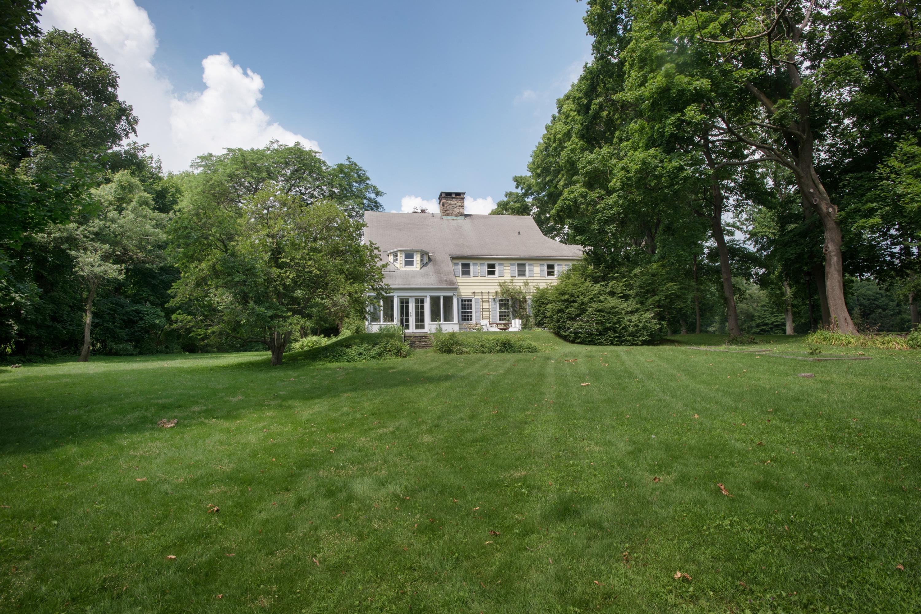 65 Oenoke Ridge New Canaan, CT 06840 - Photo 20 of 22 a front view of a house with a yard