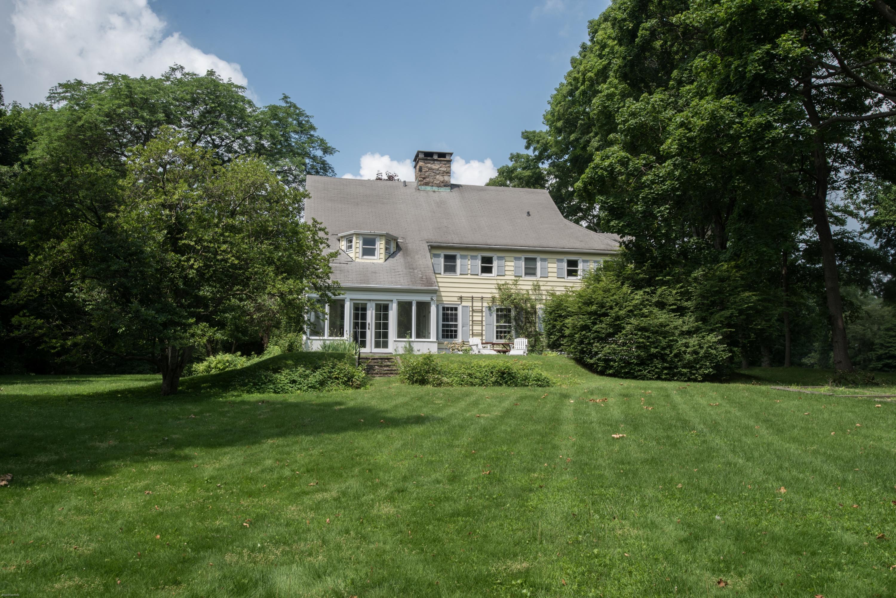 65 Oenoke Ridge New Canaan, CT 06840 - Photo 21 of 22 a aerial view of a house next to a big yard and large trees