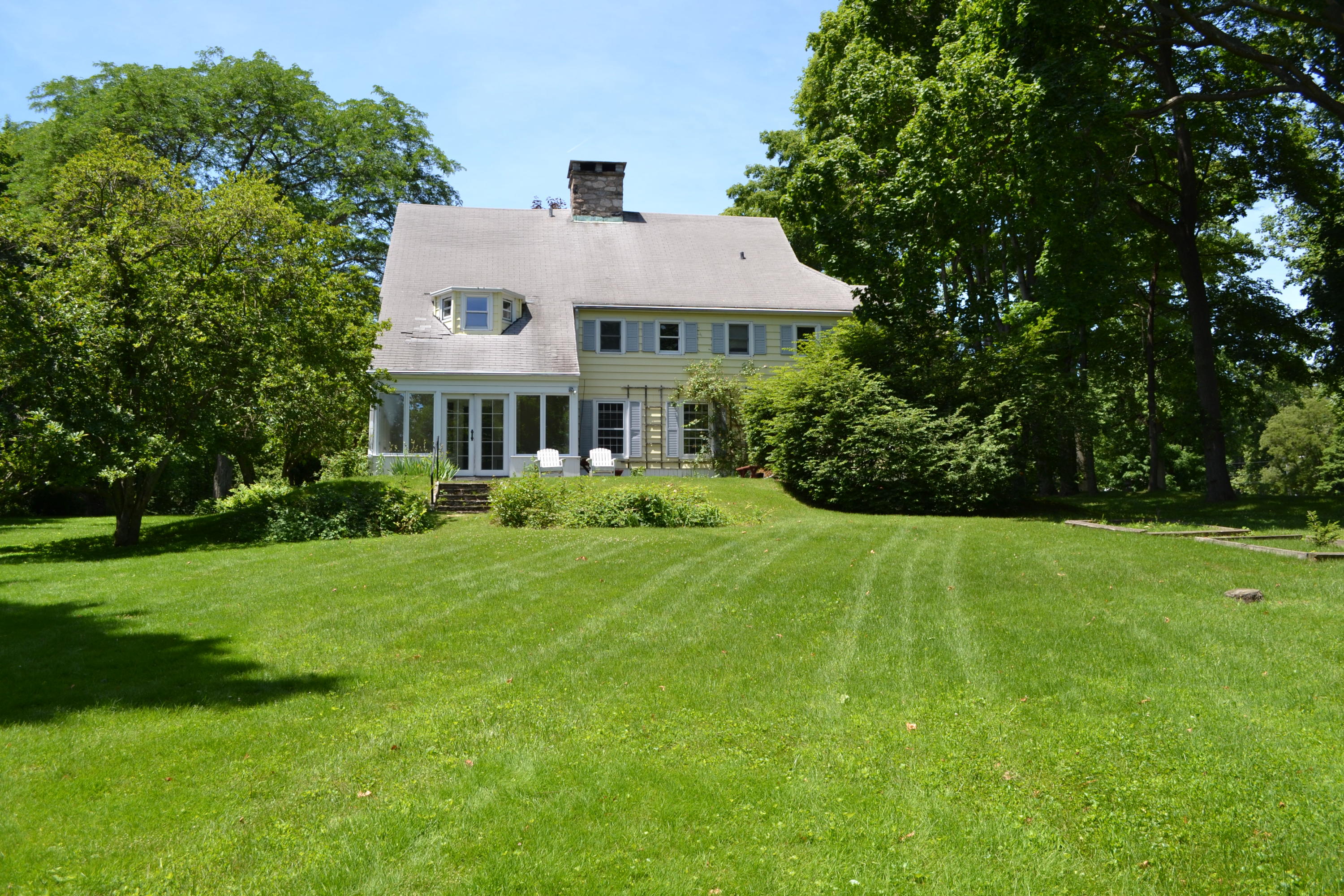 65 Oenoke Ridge New Canaan, CT 06840 - Photo 22 of 22 a front view of a house with a yard
