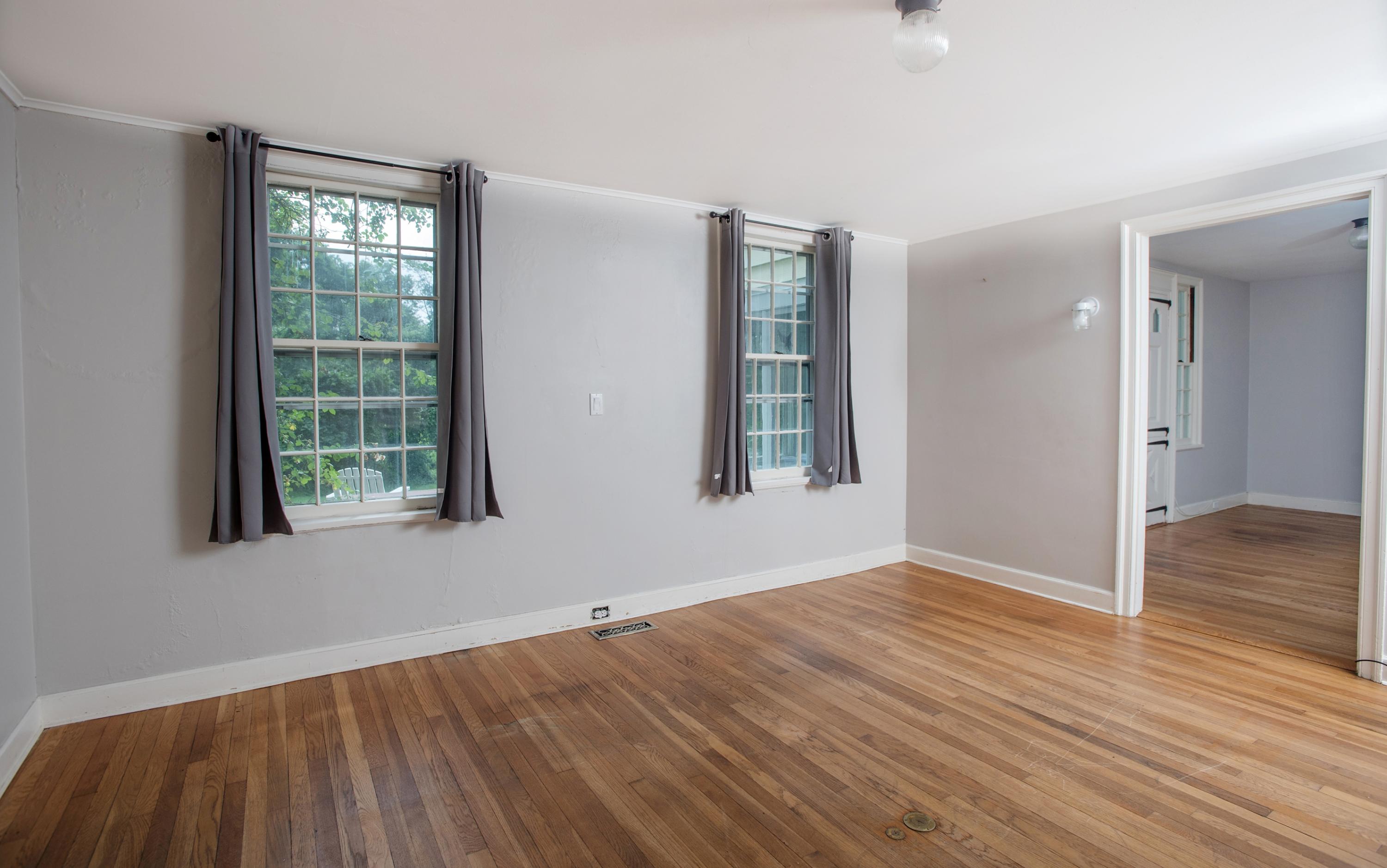 65 Oenoke Ridge New Canaan, CT 06840 - Photo 6 of 22 a view of an empty room with wooden floor and a window