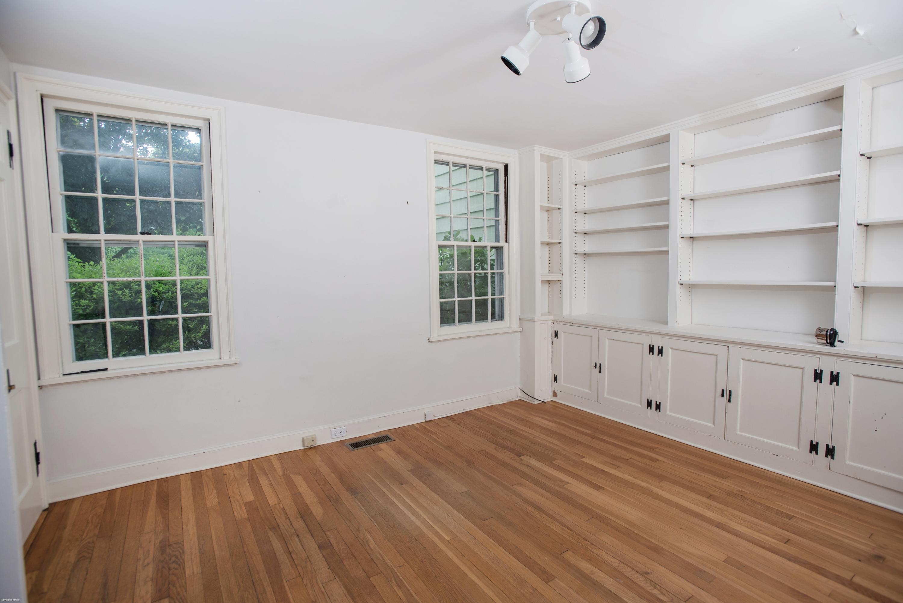 65 Oenoke Ridge New Canaan, CT 06840 - Photo 8 of 22 a view of empty room with wooden floor and cabinet