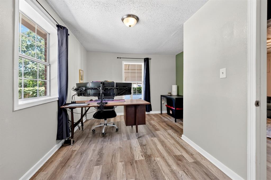 810 Edna Street Athens, TX 75751 - Photo 16 of 28 Room with wood-finish flooring, light grey walls, and a multi-pane window