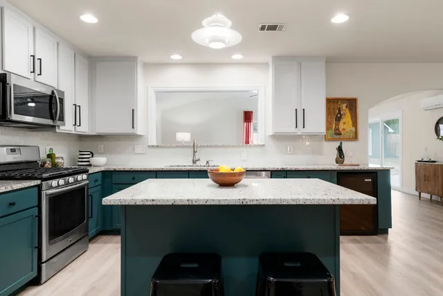 a kitchen with a sink stove and cabinets