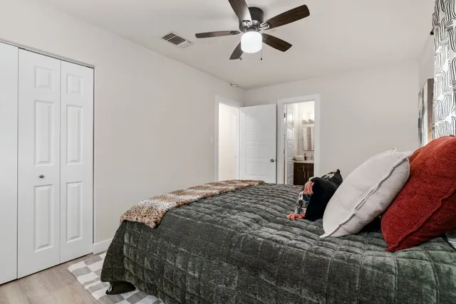 a bedroom with a bed and a chandelier