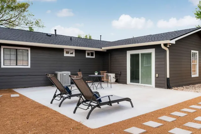 a view of a backyard with a patio and outdoor seating