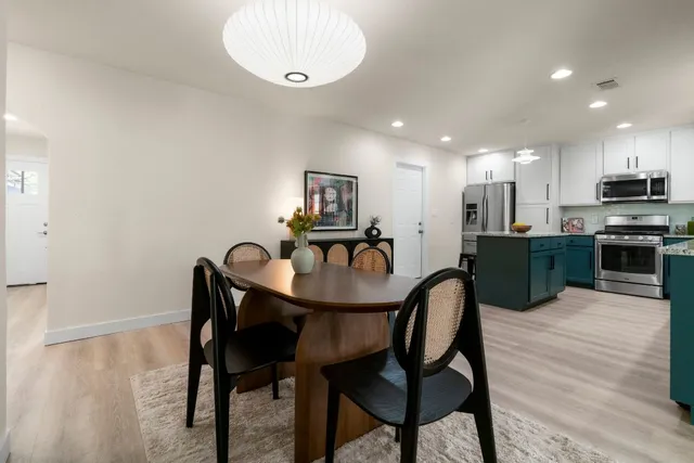 a view of a dining room with furniture and wooden floor