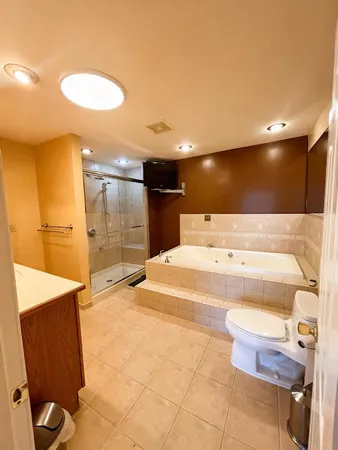a bathroom with a bathtub shower sink and toilet