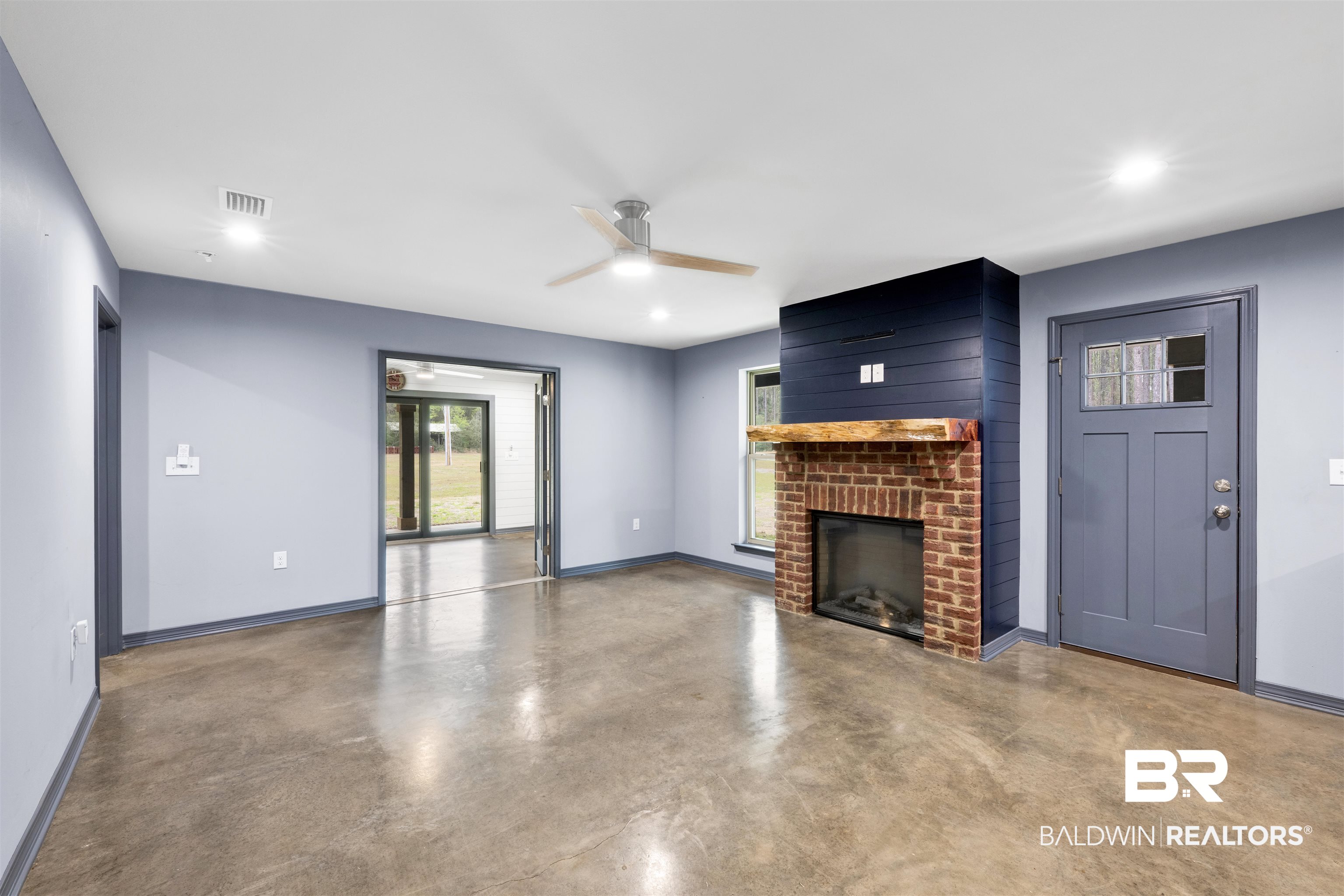 36397 Alexandria Trail Stapleton, AL 36578 - Photo 25 of 65 Unfurnished living room featuring concrete floors, a ceiling fan, a brick fireplace, and recessed lighting