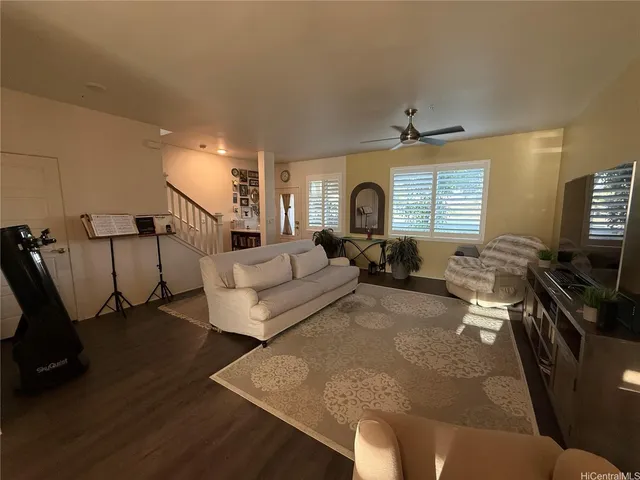 a living room with furniture window and a flat screen tv