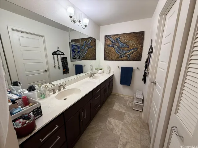 a bathroom with a double vanity sink a mirror and a shower