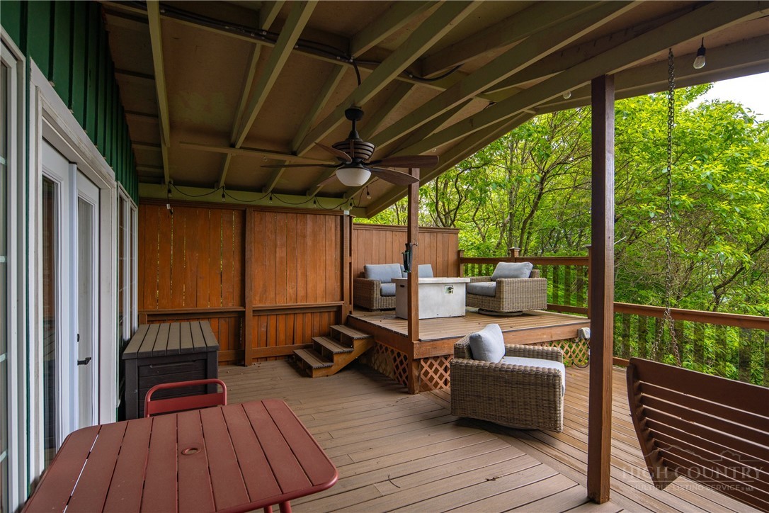 280 Chinkapin Ridge Road Seven Devils, NC 28604 - Photo 23 of 40 a view of a balcony with chairs and wooden floor