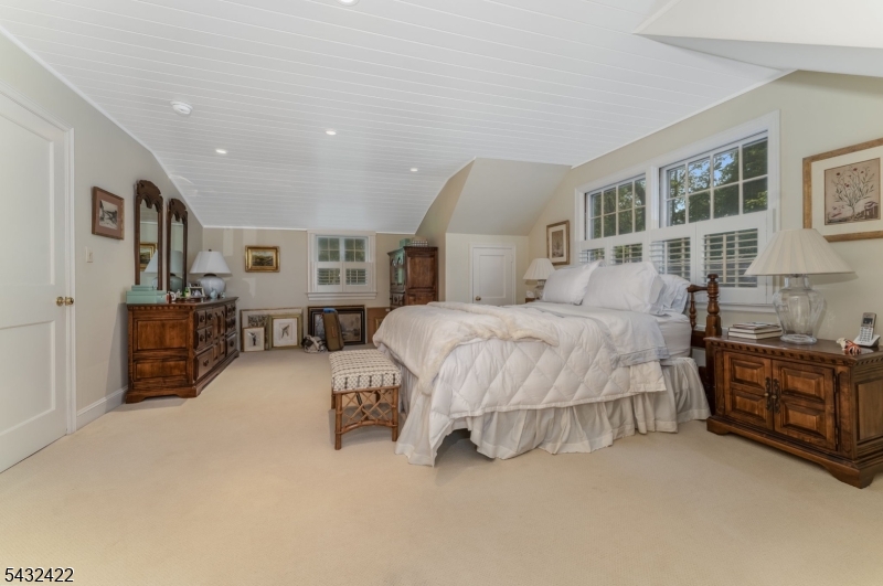 11 New Street Mendham, NJ 07945 - Photo 21 of 35 a spacious bedroom with a bed couch and a dresser