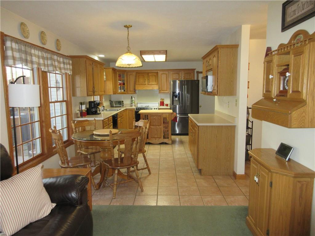 171 Bear Creek Road Prospect, PA 16052 - Photo 23 of 28 a view of a dining room with furniture a chandelier and wooden floor