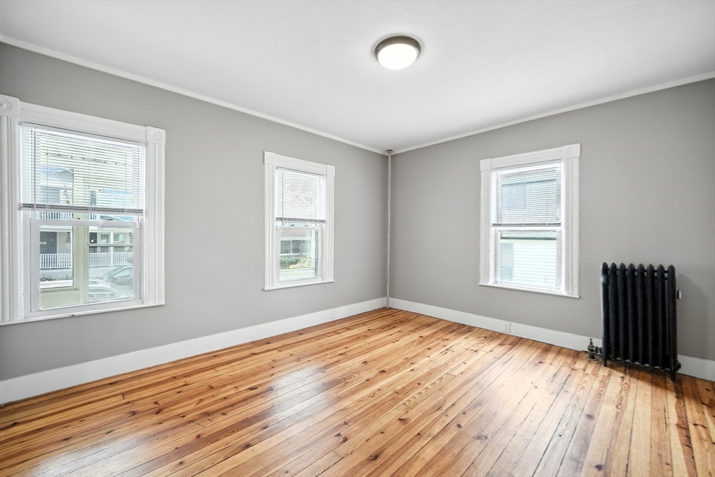 30 Beauchamp Street Springfield, MA 01107 - Photo 13 of 30 a view of an empty room with wooden floor and a window