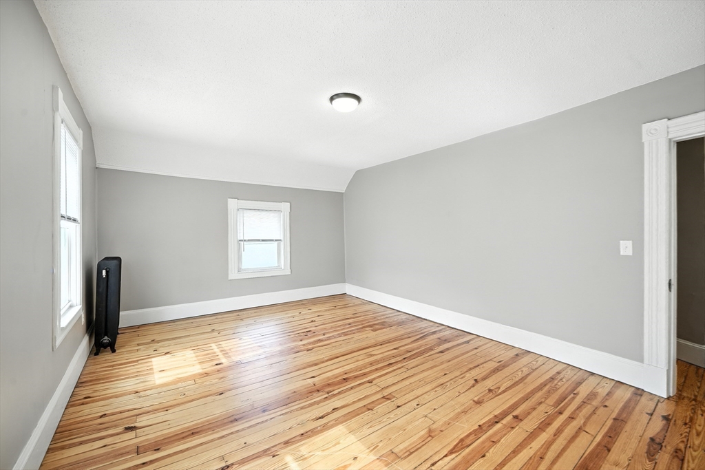 30 Beauchamp Street Springfield, MA 01107 - Photo 18 of 30 a view of empty room with wooden floor and fan