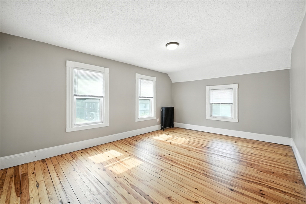 30 Beauchamp Street Springfield, MA 01107 - Photo 19 of 30 an empty room with wooden floor and windows