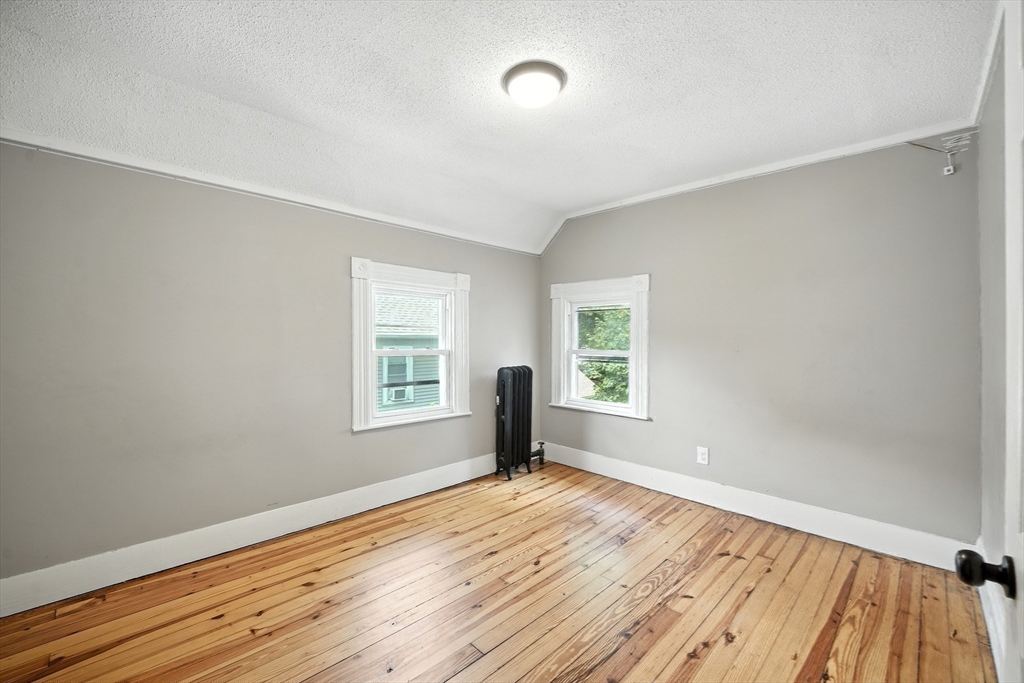 30 Beauchamp Street Springfield, MA 01107 - Photo 24 of 30 an empty room with wooden floor and windows