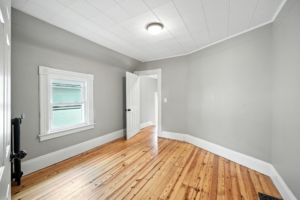 30 Beauchamp Street Springfield, MA 01107 - Photo 26 of 30 a view of an empty room with wooden floor and a window