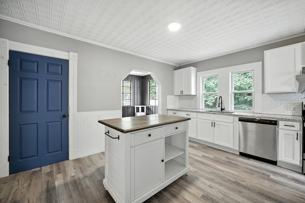 30 Beauchamp Street Springfield, MA 01107 - Photo 28 of 30 a kitchen with granite countertop white cabinets and white appliances